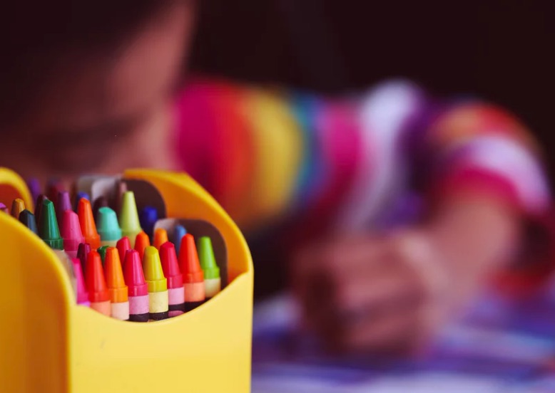 toddler with crayons